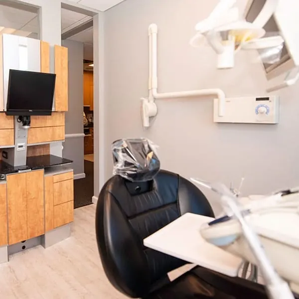 A treatment room with a monitor beside the chair.